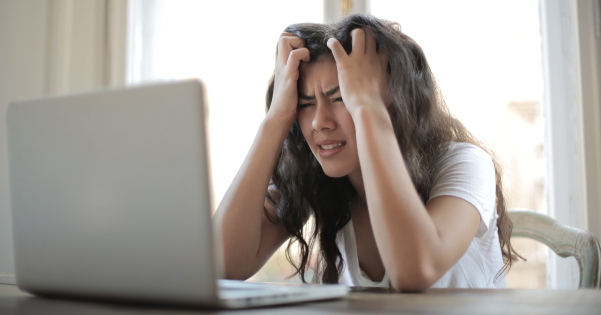 Confused woman looking at laptop