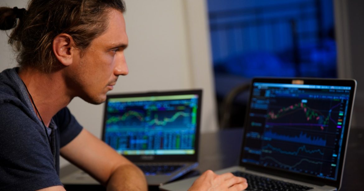 Man looking at crypto graphs Man looking at crypto graphs