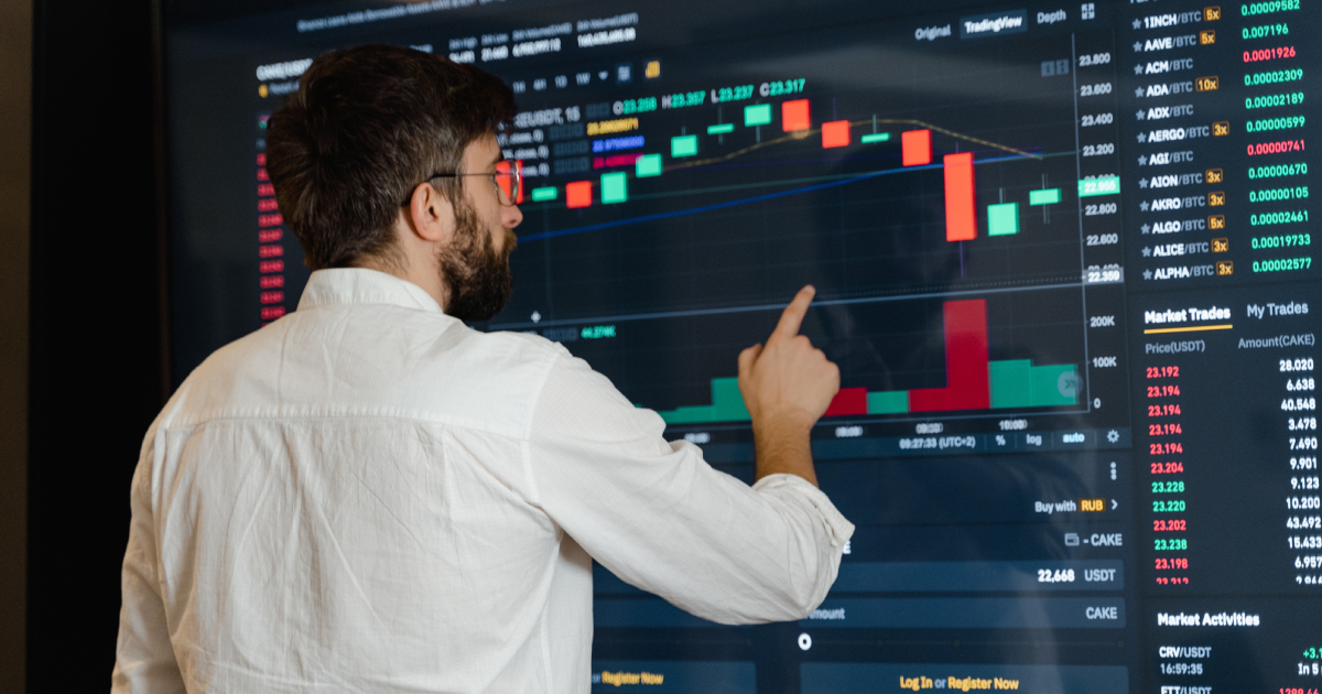 Man in front of coin graph