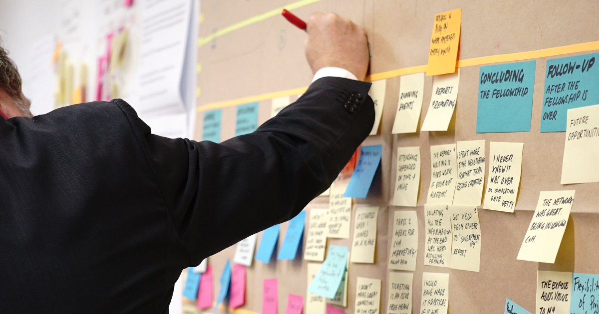 Person writing on sticky wall