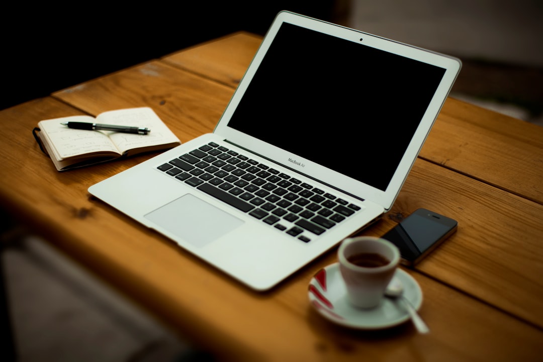 MacBook Air on brown wooden table web development, coding, internship, computer screen