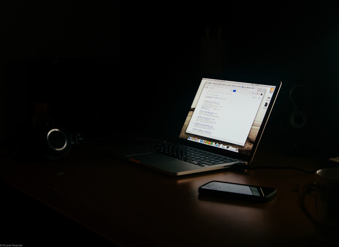 a laptop computer sitting on top of a wooden desk student laptop notes research