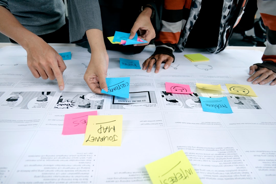 person in gray shirt holding white printer paper startup team planning technology