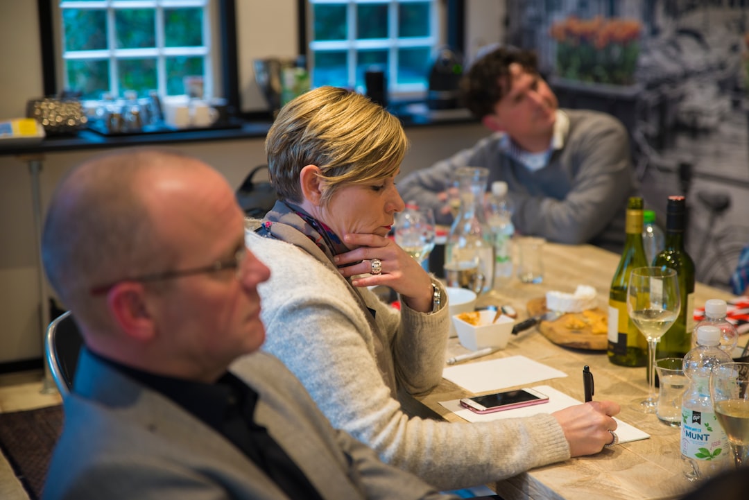 woman in grey sweat shirt writing on table stakeholder meeting, data discussion, communication skills