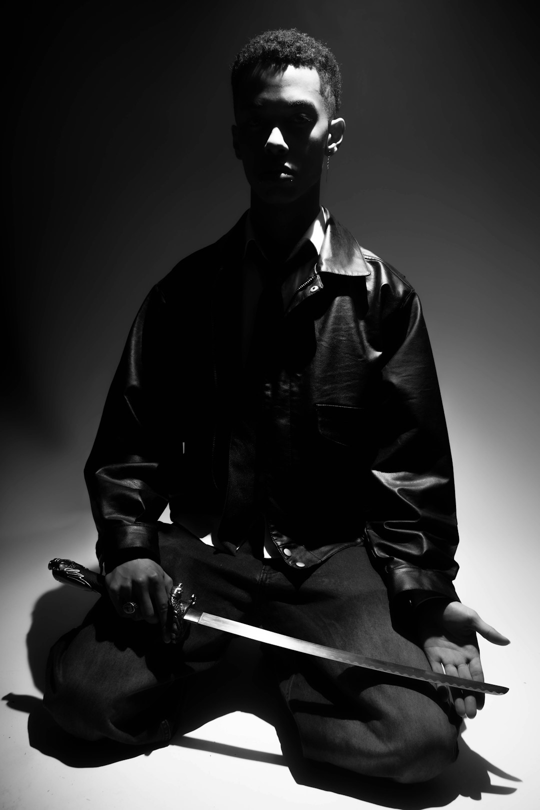 A man kneels, holding a sword. path of exile 2 monk martial arts combat