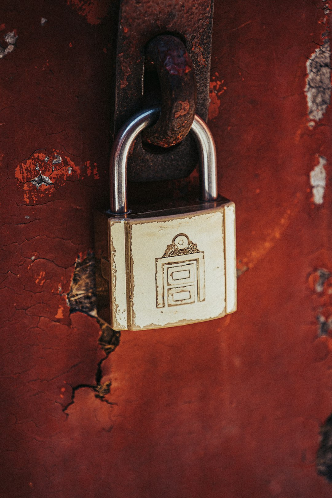 a padlock attached to a rusted red wall email security privacy encryption