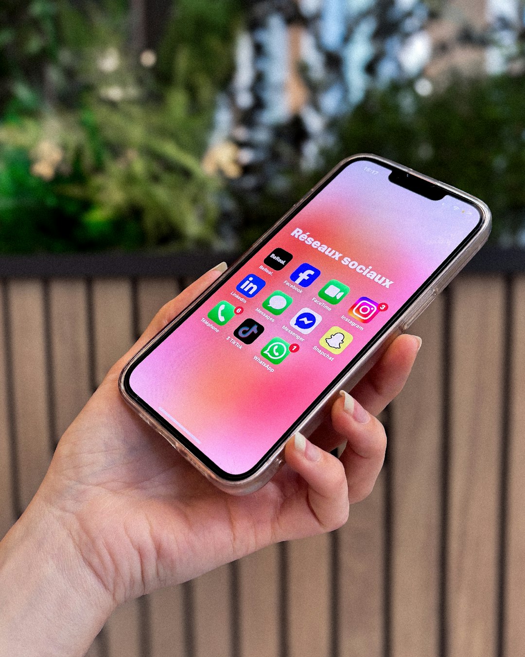 Hand holding smartphone with social media apps facebook smartphone profile apps