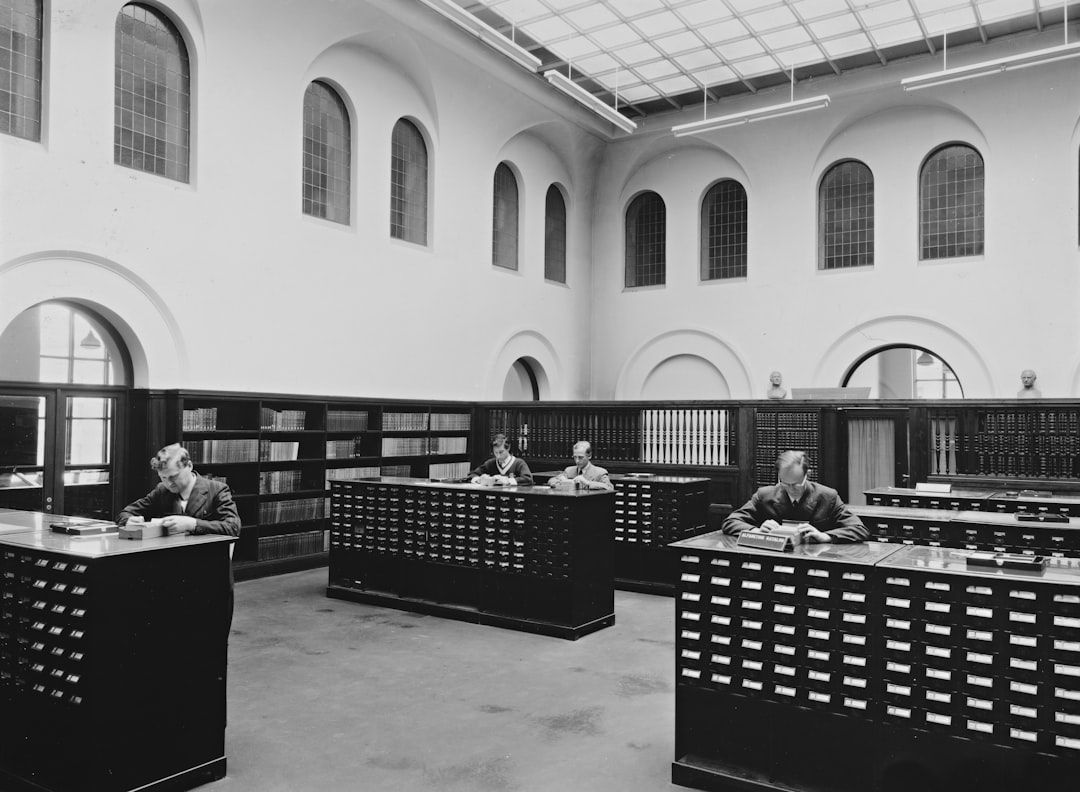 a black and white photo of people in a library public computers, people at library, tech access