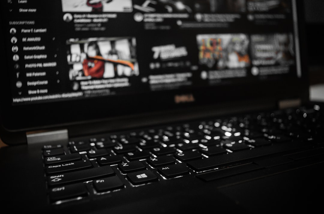 black laptop computer turned on displaying game application documentary streaming platform dashboard analytics laptop